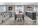 Bright dining area featuring a modern chandelier, stylish table setting, and a view to the living space at 976 Cherry Tree Ln, Greenwood, IN 46143