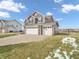 Side view of a two-story home with a three-car garage and well-maintained landscaping at 976 Cherry Tree Ln, Greenwood, IN 46143