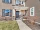 Charming front entrance with brick accents, black door and shutters, complemented by a cozy covered porch at 976 Cherry Tree Ln, Greenwood, IN 46143