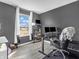 Comfortable home office space with a large window offering ample natural light and gray accent wall at 976 Cherry Tree Ln, Greenwood, IN 46143