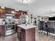Modern kitchen featuring stainless steel appliances, a kitchen island with bar stool seating, and wood floors at 976 Cherry Tree Ln, Greenwood, IN 46143