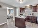 Well-lit kitchen boasting wood cabinets, an island, and seamless transition to the living area at 976 Cherry Tree Ln, Greenwood, IN 46143