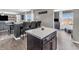 Kitchen island with marble countertop next to bar seating and a dining area in an open-concept design at 976 Cherry Tree Ln, Greenwood, IN 46143