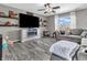 Cozy living room featuring a fireplace, large TV, comfortable seating, and bright windows at 976 Cherry Tree Ln, Greenwood, IN 46143