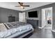 The main bedroom features a ceiling fan and a large television at 976 Cherry Tree Ln, Greenwood, IN 46143