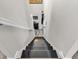 This home features a stairway with a black painted steps and white risers and handrail at 976 Cherry Tree Ln, Greenwood, IN 46143
