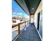 Inviting balcony with wood and metal railing, and tiled flooring, perfect for outdoor enjoyment and relaxation at 1046 Nelson Ave, Indianapolis, IN 46203
