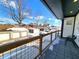 Inviting balcony with wood and metal railing, and tiled flooring, perfect for outdoor enjoyment and relaxation at 1046 Nelson Ave, Indianapolis, IN 46203