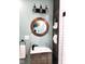 Nautical-themed bathroom with vessel sink, unique porthole mirror, and industrial-style lighting at 1046 Nelson Ave, Indianapolis, IN 46203