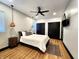 Bright bedroom with a ceiling fan, modern lighting, and minimalist decor at 1046 Nelson Ave, Indianapolis, IN 46203