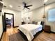Bright bedroom with a view of the kitchen, featuring a ceiling fan and a decorative rug at 1046 Nelson Ave, Indianapolis, IN 46203