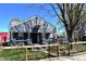 Charming gray home featuring a welcoming front porch and tidy lawn with a wooden fence at 1046 Nelson Ave, Indianapolis, IN 46203