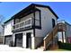 Two-story garage with black doors, white siding, and an elevated deck at 1046 Nelson Ave, Indianapolis, IN 46203