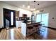 Modern kitchen with stainless steel appliances, a black countertop island, and a brick accent wall at 1046 Nelson Ave, Indianapolis, IN 46203