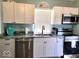 Well-equipped kitchen featuring white cabinets, stainless steel appliances, and granite countertops for cooking convenience at 1046 Nelson Ave, Indianapolis, IN 46203