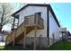 Back view of white two-story home with an elevated deck and exterior staircase at 1046 Nelson Ave, Indianapolis, IN 46203