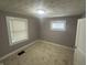 Comfortable bedroom featuring plush carpet, natural light, and fresh paint at 1105 Winfield Ave, Indianapolis, IN 46222