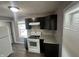 Modern kitchen with sleek dark cabinets, granite countertops, and stainless steel oven at 1105 Winfield Ave, Indianapolis, IN 46222