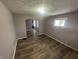 Open living room featuring updated flooring, neutral paint, and a charming archway to the next room at 1105 Winfield Ave, Indianapolis, IN 46222
