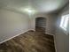 Inviting living room with modern wood-look flooring and an archway leading to another room at 1105 Winfield Ave, Indianapolis, IN 46222