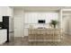 Modern kitchen featuring white cabinets, stainless steel appliances, and counter seating at the island at 11542 Aubrey Ln, Fishers, IN 46040