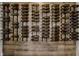 Custom wall-mounted wine rack displays dozens of wine bottles; a stylish way to store and showcase your collection at 11901 Lyndale Dr, Fishers, IN 46040