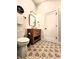 Charming bathroom features floral tile flooring, a wood vanity, and stylish fixtures at 1328 E Minnesota St, Indianapolis, IN 46203