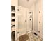 Modern bathroom with tiled walk-in shower, glass door, and stylish floral tile flooring, plus built-in storage at 1328 E Minnesota St, Indianapolis, IN 46203