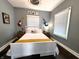 This bedroom features unique wall art, window, and ceiling fan at 1328 E Minnesota St, Indianapolis, IN 46203