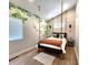Unique bedroom with a suspended bed, nature-themed mural, and modern lighting fixtures, creating a serene space at 1328 E Minnesota St, Indianapolis, IN 46203