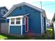 The side of the house is blue with a small awning over a red door at 1328 E Minnesota St, Indianapolis, IN 46203