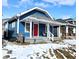Charming blue home with a bright red door and covered front porch, perfect for enjoying the neighborhood view at 1328 E Minnesota St, Indianapolis, IN 46203