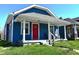 Charming blue home with a vibrant red front door and a welcoming covered porch at 1328 E Minnesota St, Indianapolis, IN 46203