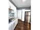Well-appointed kitchen with white cabinets, stainless steel refrigerator, and dark flooring at 1328 E Minnesota St, Indianapolis, IN 46203