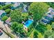 Captivating aerial view of an outdoor pool area surrounded by a lush green garden and tall mature trees at 1409 N Park Ave, Indianapolis, IN 46202