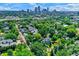 Picturesque neighborhood with tree-lined streets and diverse homes with skyline in distance at 1409 N Park Ave, Indianapolis, IN 46202