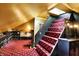 Attic with golden ceiling and stairs leading to a dressing area with shoe shelves and dressing table at 1409 N Park Ave, Indianapolis, IN 46202