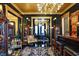Home bar and adjoining dining room featuring matching chandeliers and vintage decor at 1409 N Park Ave, Indianapolis, IN 46202