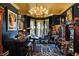 Home bar featuring a black and gold color scheme and a large, ornate chandelier at 1409 N Park Ave, Indianapolis, IN 46202