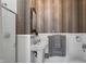Elegant bathroom featuring tiled shower, unique wall mirror, and a pedestal sink with classic fixtures at 1409 N Park Ave, Indianapolis, IN 46202
