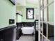 Bright bathroom features a vintage style clawfoot tub, classic tile floor, and decorative window at 1409 N Park Ave, Indianapolis, IN 46202