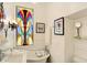 Bright white bathroom featuring a clawfoot tub, stained glass window and pedestal sink at 1409 N Park Ave, Indianapolis, IN 46202