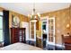 A traditionally decorated primary bedroom with dark wood floors, adjacent sitting room and vintage decor at 1409 N Park Ave, Indianapolis, IN 46202