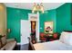 Bright bedroom featuring stylish decor, an ornate mirror, and an inviting doorway to another room at 1409 N Park Ave, Indianapolis, IN 46202