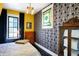 Stylish bedroom featuring dark trim, a decorative glass window, and yellow and black wallpaper at 1409 N Park Ave, Indianapolis, IN 46202