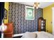 Bright and airy bedroom featuring an eye-catching wallpaper accent wall and plenty of natural light at 1409 N Park Ave, Indianapolis, IN 46202