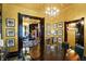 Chandelier illuminates the dining room, revealing access to other parts of the house at 1409 N Park Ave, Indianapolis, IN 46202