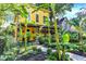 Striking yellow home with a landscaped front yard and a welcoming porch at 1409 N Park Ave, Indianapolis, IN 46202