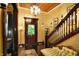 Elegant foyer boasts hardwood floors, vintage furniture, and a grand staircase at 1409 N Park Ave, Indianapolis, IN 46202
