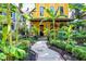 Inviting yellow home with lush landscaping and a charming walkway at 1409 N Park Ave, Indianapolis, IN 46202